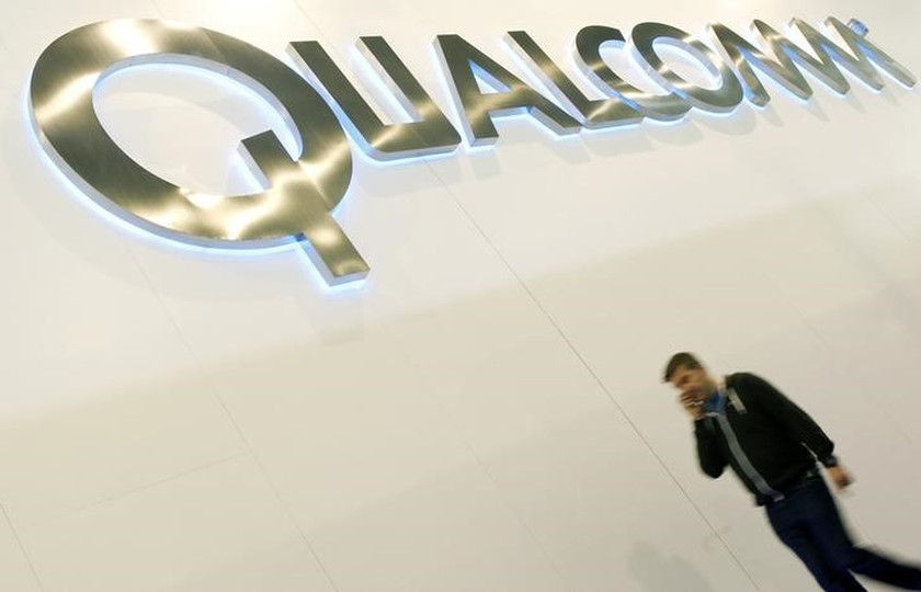 A man walks past a Qualcomm advertising logo at the Mobile World Congress at Barcelona, February 27, 2013.u00e2u20acu201d Reuters pic 