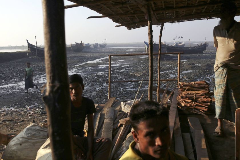 Rohingya fishermen pass the time near their boats at Thae Chaung refugee camp outside Sittwe November 13, 2014. u00e2u20acu201d Reuters pic