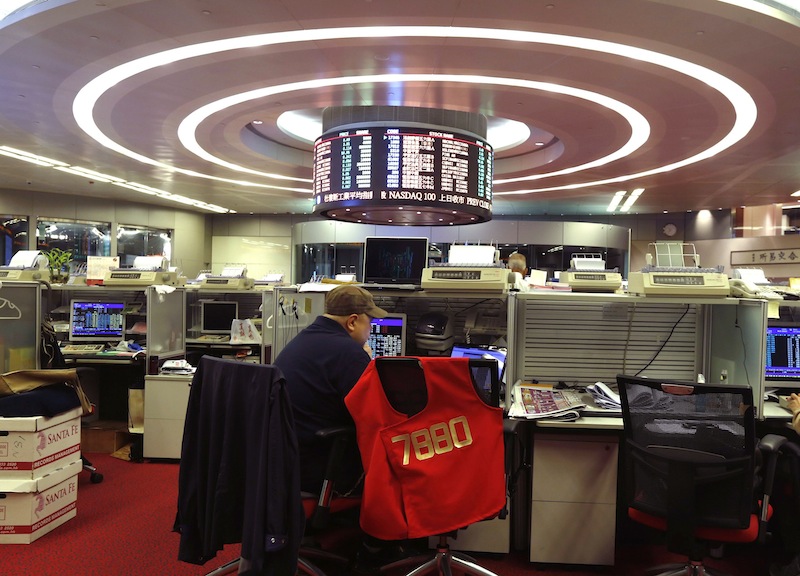 A floor trader monitors share prices during morning trading at the Hong Kong Stock Exchange in Hong Kong November 17, 2014. u00e2u20acu201d Reuters pic