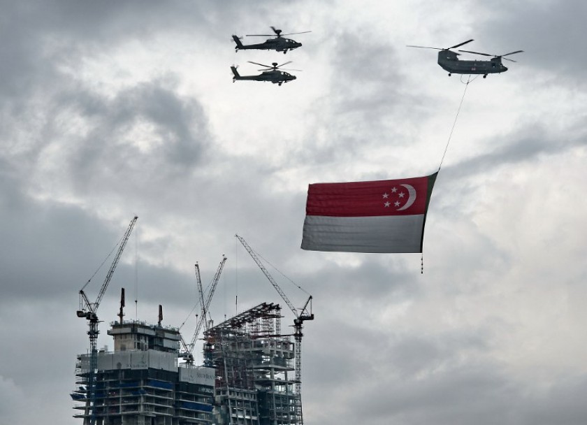 Singapore said it would provide military support to the US-led coalition fighting the Islamic State. File picture shows a Republic of Singapore Air Force Chinook helicopter (top right) flying a giant national flag on National Day, August 9, 2014. u00e2u20acu201d AFP 