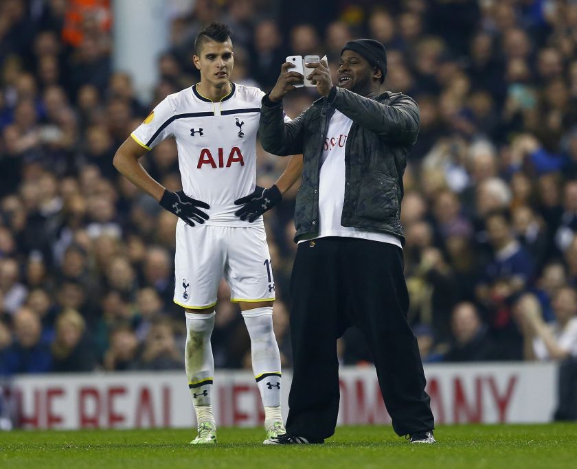 A spectator runs onto the pitch and takes a 'selfie' of himself and Tottenham Hotspur's Erik Lamela (left) during their match against Partizan Belgrade at White Hart Lane, London November 27, 2014. u00e2u20acu2022 Reuters pic