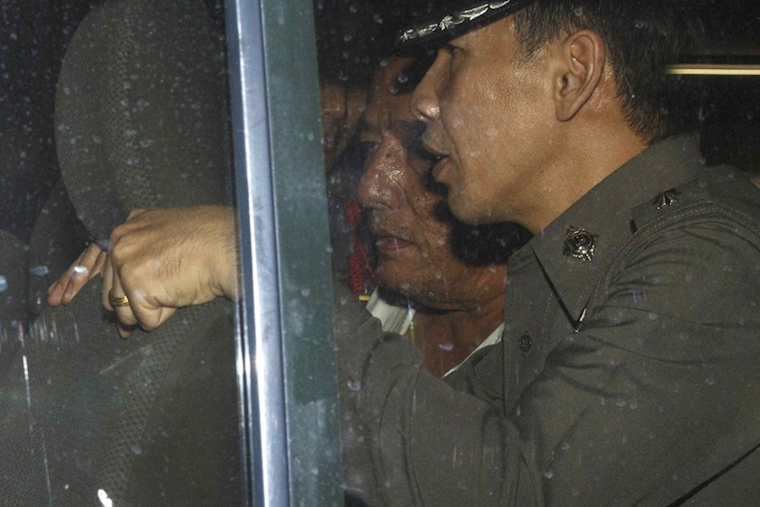 Police Lieutenant General Pongpat Chayaphan (centre), commissioner of the Central Investigation Bureau is escorted by police officers as he leaves the Criminal Court in Bangkok November 24, 2014. u00e2u20acu201d Reuters pic