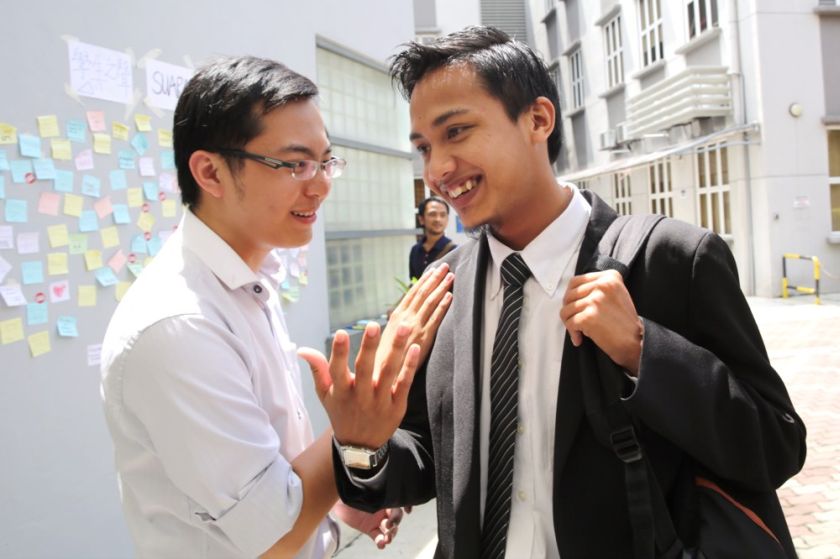 A student greets Fahmi Zainol after the hearing, November 7, 2014. u00e2u20acu2022 Picture by Choo Choy May
