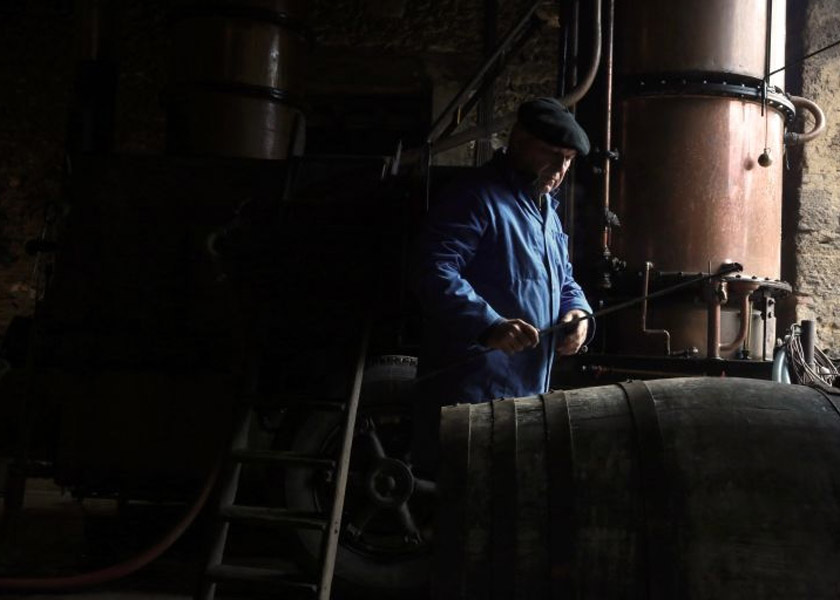 An employee of Marc Saint-Martin, a wine grower and an itinerant Armagnac home distiller, December 8, 2014. u00e2u20acu201d AFP pic
