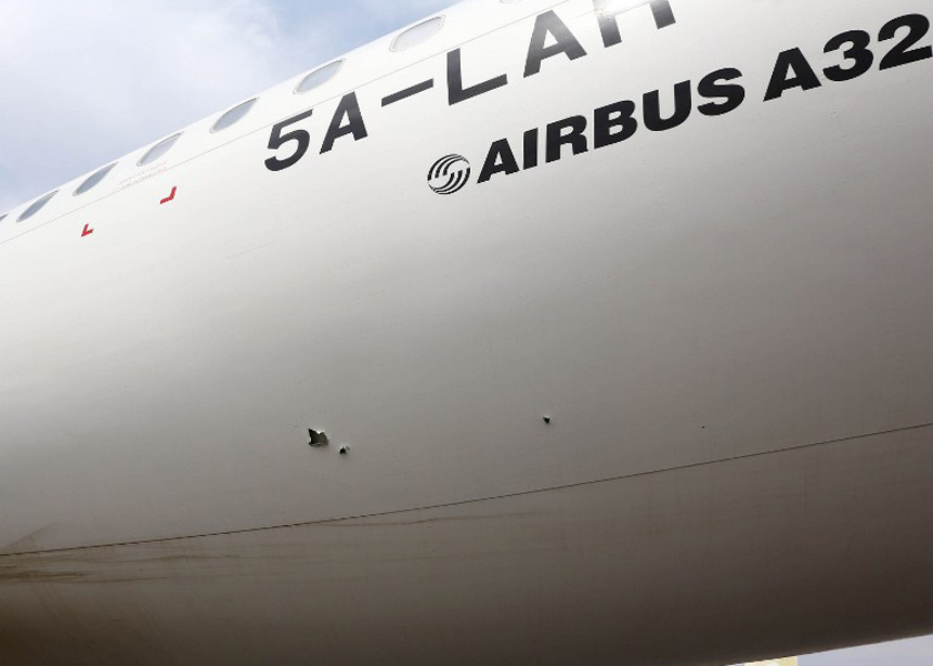 Bullet holes are seen on the fuselage of a Libyan Airlines' Airbus A320 airplane at Tripoli international airport in the Libyan capital on July 14, 2014. u00e2u20acu201d AFP pic