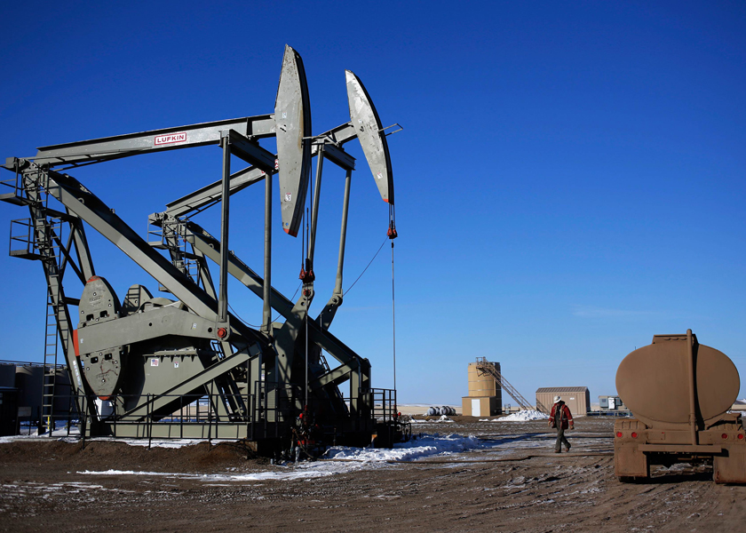 A man walks onto an oil drilling pump site in McKenzie County outside of Williston, North Dakota, December 18, 2014. u00e2u20acu201d Reuters pic