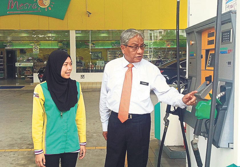 Hasan checks on the sale of RON97 at a Petronas petrol station in Putrajaya. u00e2u20acu201d Picture by Malay Mailn