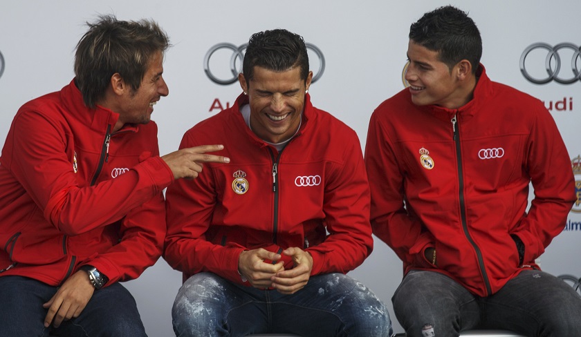 Real Madrid's soccer players Cristiano Ronaldo (centre), James Rodriguez and Fabio Coentrao laugh during a promotional event in Madrid December 1, 2014. u00e2u20acu201d Reuters pic