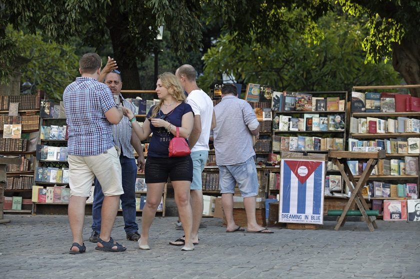 Tourists talk in a park beside books displayed for sale in Old Havana December 18, 2014. u00e2u20acu201d Reuters pic