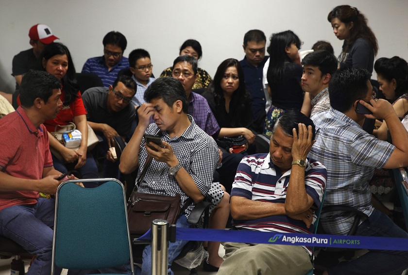 Family of passengers onboard missing AirAsia flight QZ8501 react at a waiting area in Juanda International Airport, Surabaya December 28, 2014. u00e2u20acu201d Reuters pic
