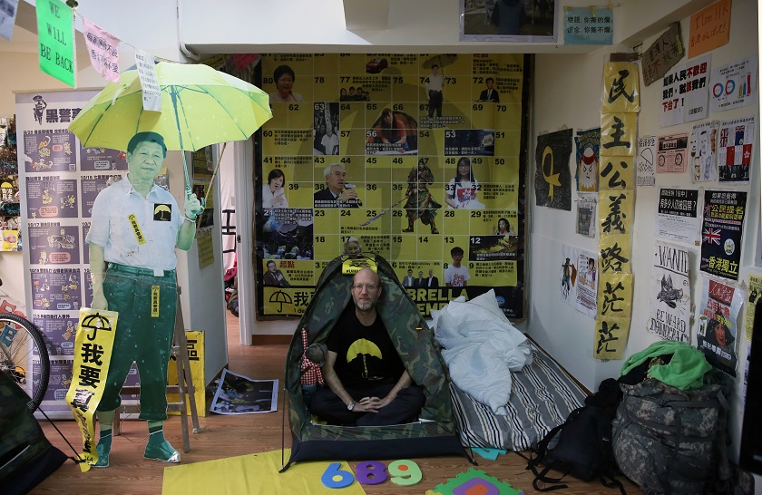 Stephen Thompson sitting in a tent in a flat that he has turned into a recreation of the main pro-democracy protest site in Hong Kong on December 23, 2014. u00e2u20acu201d AFP pic