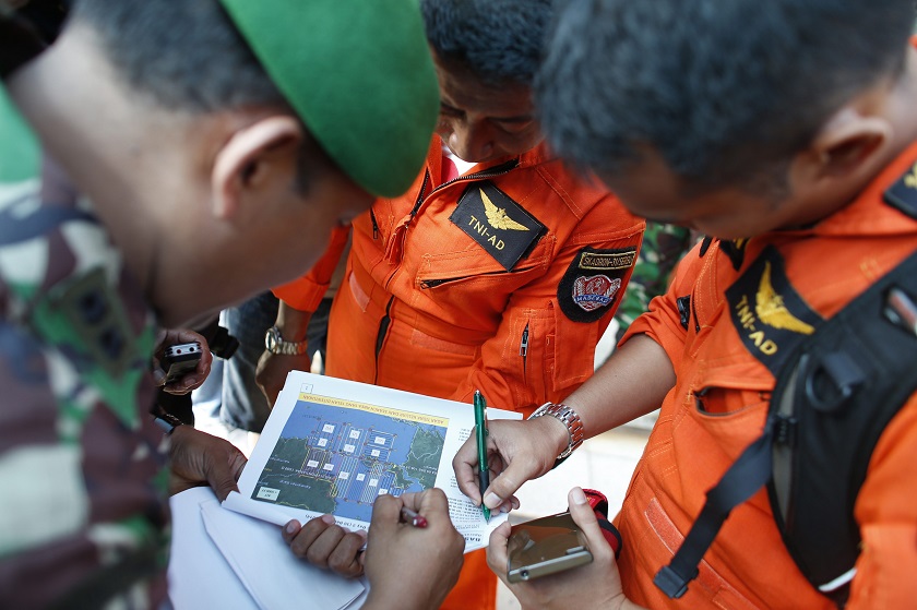 Indonesian military pilots look at a flight plan before setting out for a search mission for AirAsia's Flight QZ8501 in Pangkal Pinang, Bangka island December 30, 2014. u00e2u20acu201d Reuters pic