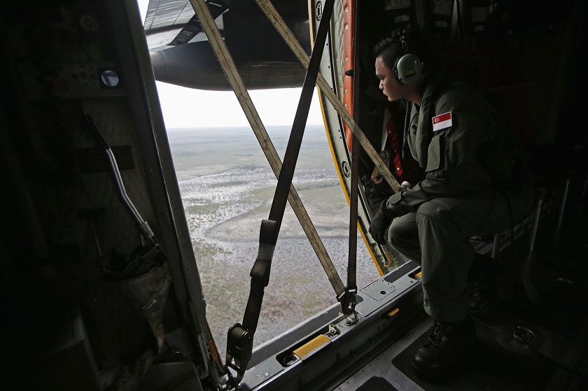 A Republic of Singapore Air Force personnel surveys the waters during a search and locate operation for the missing AirAsia flight QZ8501 plane at an undisclosed search area December 30, 2014. u00e2u20acu201d Reuters pic