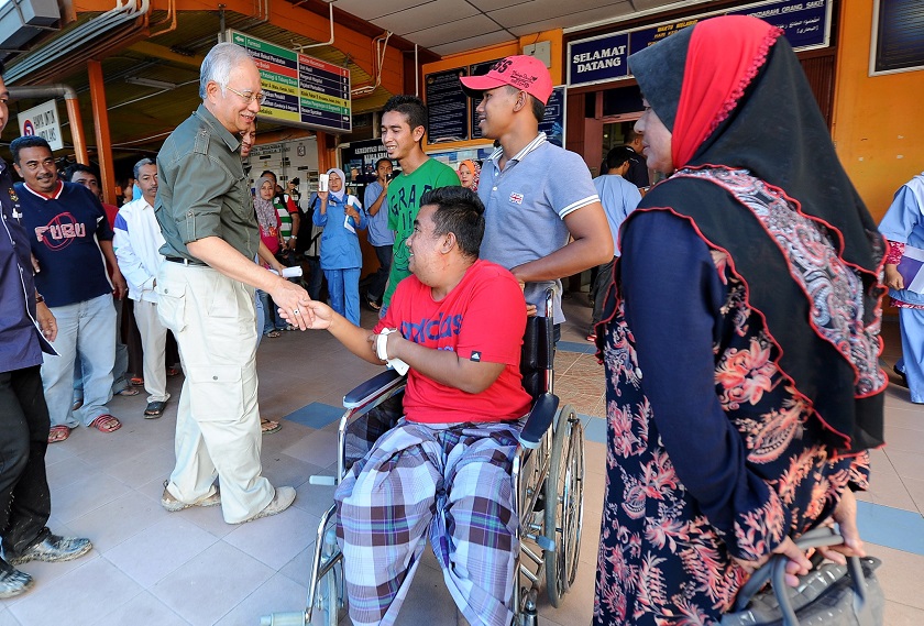 Prime Minister Datuk Seri Najib Tun Razak shakes a patientu00e2u20acu2122s hand during his visit to the Kuala Krai Hospital, December 30, 2014. u00e2u20acu201d Bernama pic