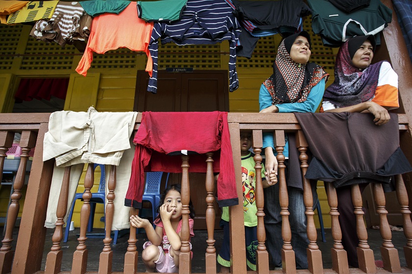 People look on at a disaster evacuation centre after being evacuated due to flooding, at Tumpat in Kelantan December 29, 2014. u00e2u20acu201d Reuters pic