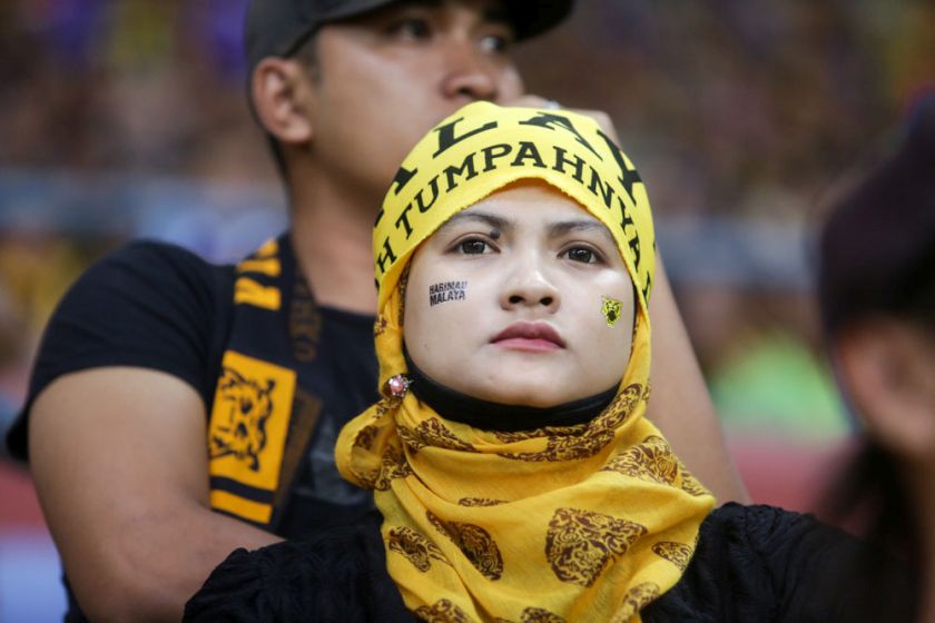 A Malaysian football fan looks on as Malaysia face Vietnam in the AFF Suzuki Cup 2014 semi-final match at the Shah Alam Stadium, December 7, 2014. u00e2u20acu201d Picture by Choo Choy May