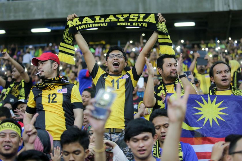 A Malaysian football fan hold up a banner as he cheers the Malaysian team on during their AFF Suzuki Cup 2014 semi-final first leg match against Vietnam at the Shah Alam Stadium, December 7, 2014. u00e2u20acu201d Picture by Choo Choy May