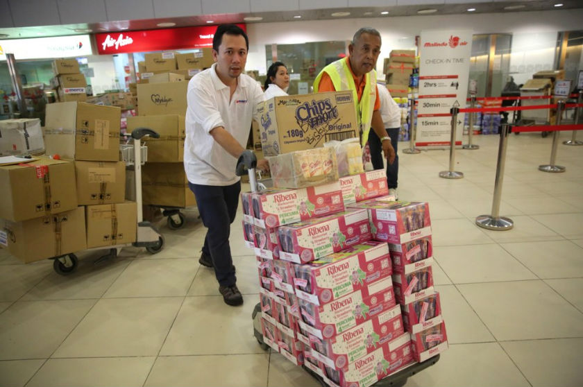 Mercy Malaysia volunteers at Subang Airport help to check in flood aid bound for Kelantan via Firefly and Malindo Airlines, December 28, 2014. u00e2u20acu201d Picture by Choo Choy May