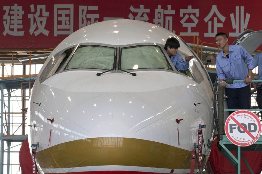 nWorkers aboard an almost completed COMAC ARJ21-700 passenger jet at a final assembly and manufacturing centre in Shanghai. u00e2u20acu201d AFP picn