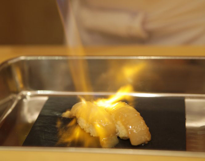 Engawa sushi is torched to give it a silky texture.