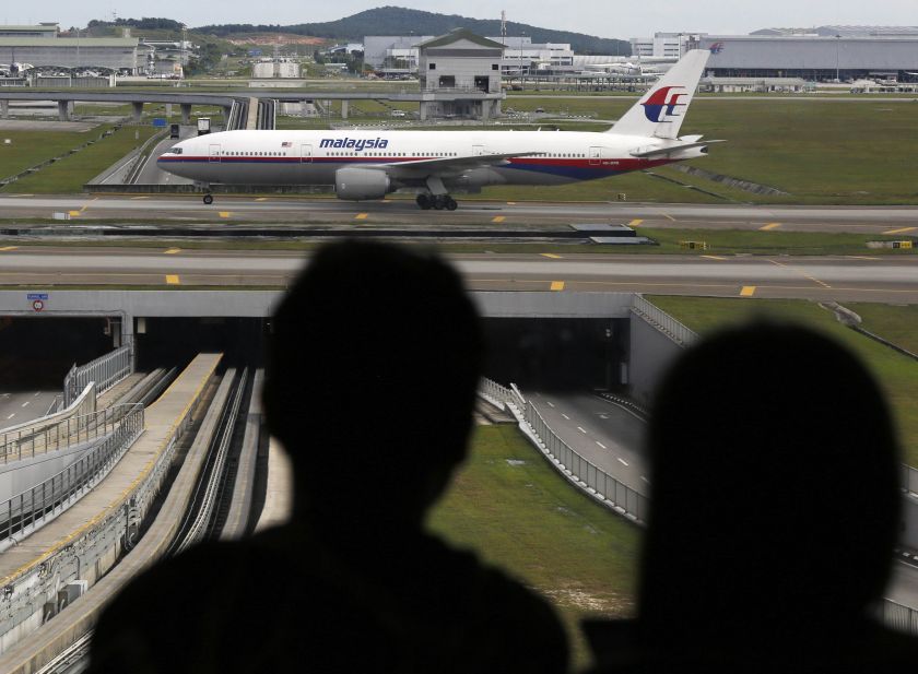 A couple watches a Malaysian Airlines aircraft at Kuala Lumpur International airport in Sepang outside Kuala Lumpur December 1, 2014. u00e2u20acu201d Reuters picn
