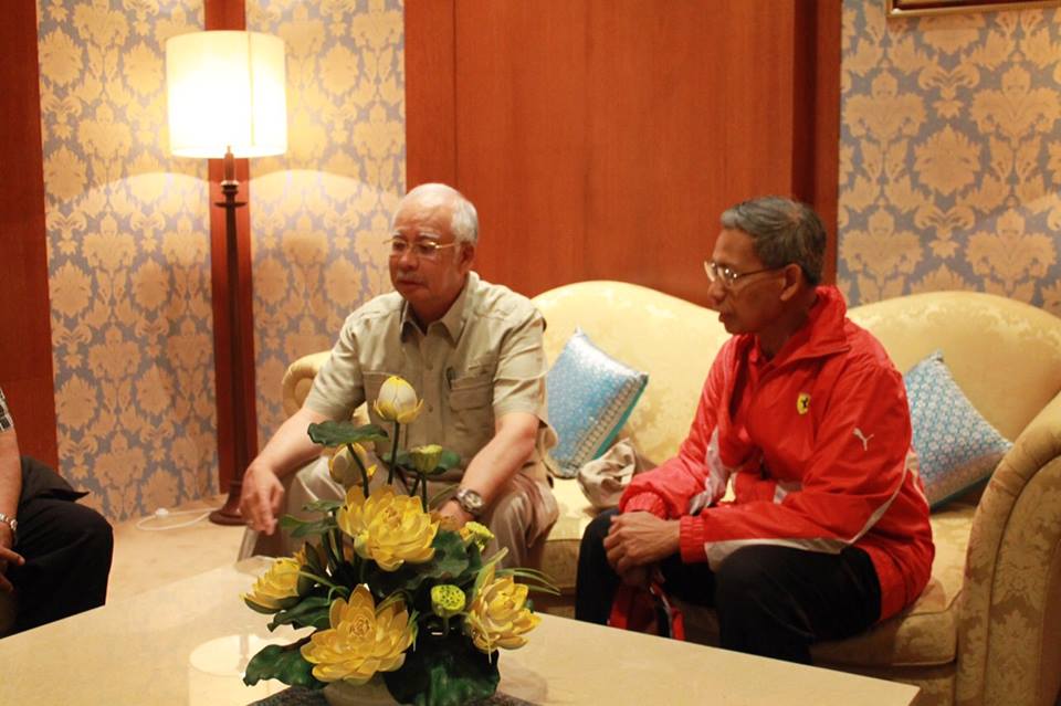 Datuk Sri Najib being briefed by the chairman of the Kelantan Flood Disaster Committee, Datuk Seri Mustapa Mohamed as at the Pengkalan Chepa airport in Kelantan, Dec 27, 2014. u00e2u20acu201d Picture courtesy of Datuk Sri Najibu00e2u20acu2122s Facebook page
