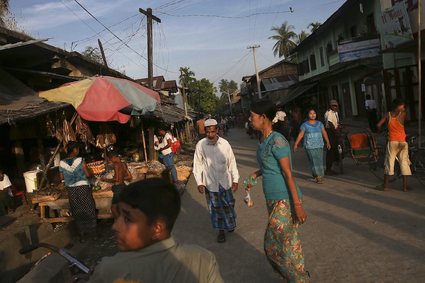 People walk at a market in Maungdaw on Nov 11. The market is where the Rohingya Muslim and Rakhine Buddhist communities meet. u00e2u20acu201d Reuters pic
