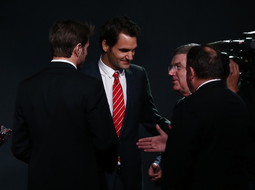 International Olympic Committee (IOC) President Thomas Bach (right) talks with Switzerland's Davis Cup tennis team member Roger Federer (left) and Stanislas Wawrinka during a ceremony in Lausanne November 24, 2014. u00e2u20acu201d Reuters pic