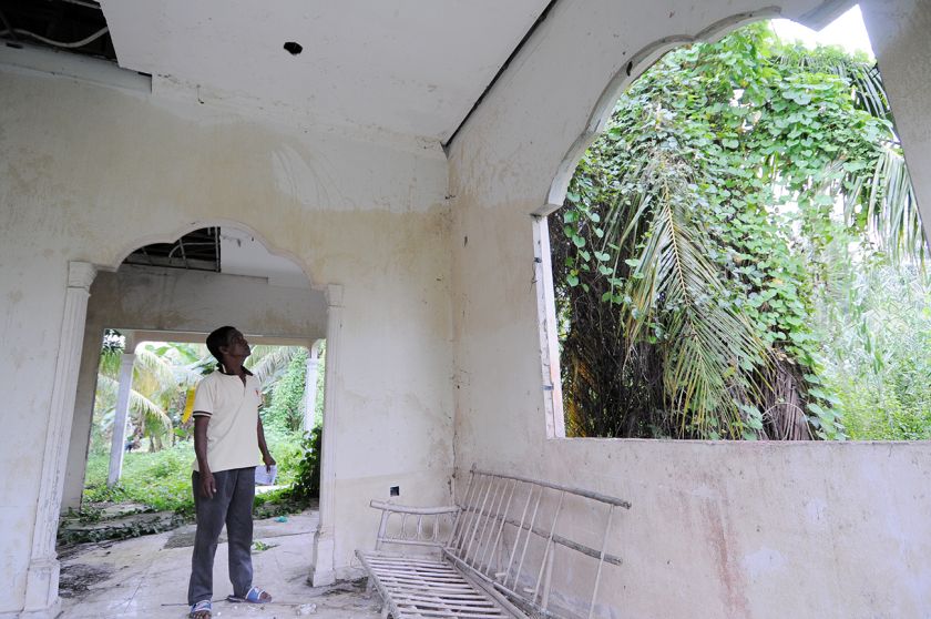 One of the villagers in Kota Kuala Muda, Abdul Majid, showing the marks made by the tsunami that destroyed one of the houses that is now left abandoned. u00e2u20acu2022 Picture by K.E.Ooi