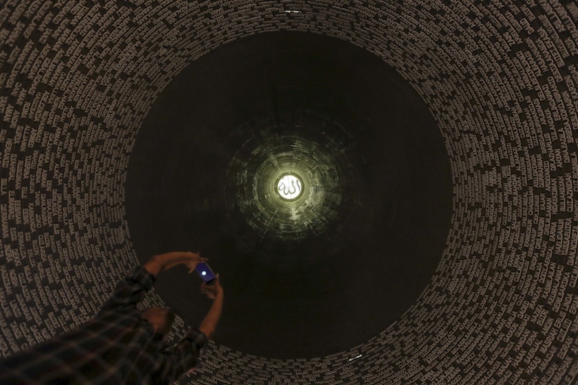 A visitor take pictures of the names of tsunami victims on the ceiling of the Aceh Tsunami Museum in Banda Aceh, December 9, 2014 in this photo taken by Antara Foto. u00e2u20acu201du00c2u00a0Reuters pic