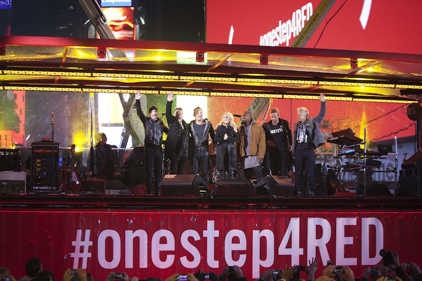 (From left) The Edge, Larry Mullen, Bruce Springsteen, Carrie Underwood, Kanye West, Chris Martin and Adam Clayton wave to the crowd after their surprise concert in support of World AIDS Day in Times Square in New York, December 1, 2014.u00c2u00a0u00e2u20acu201d Reuters pic