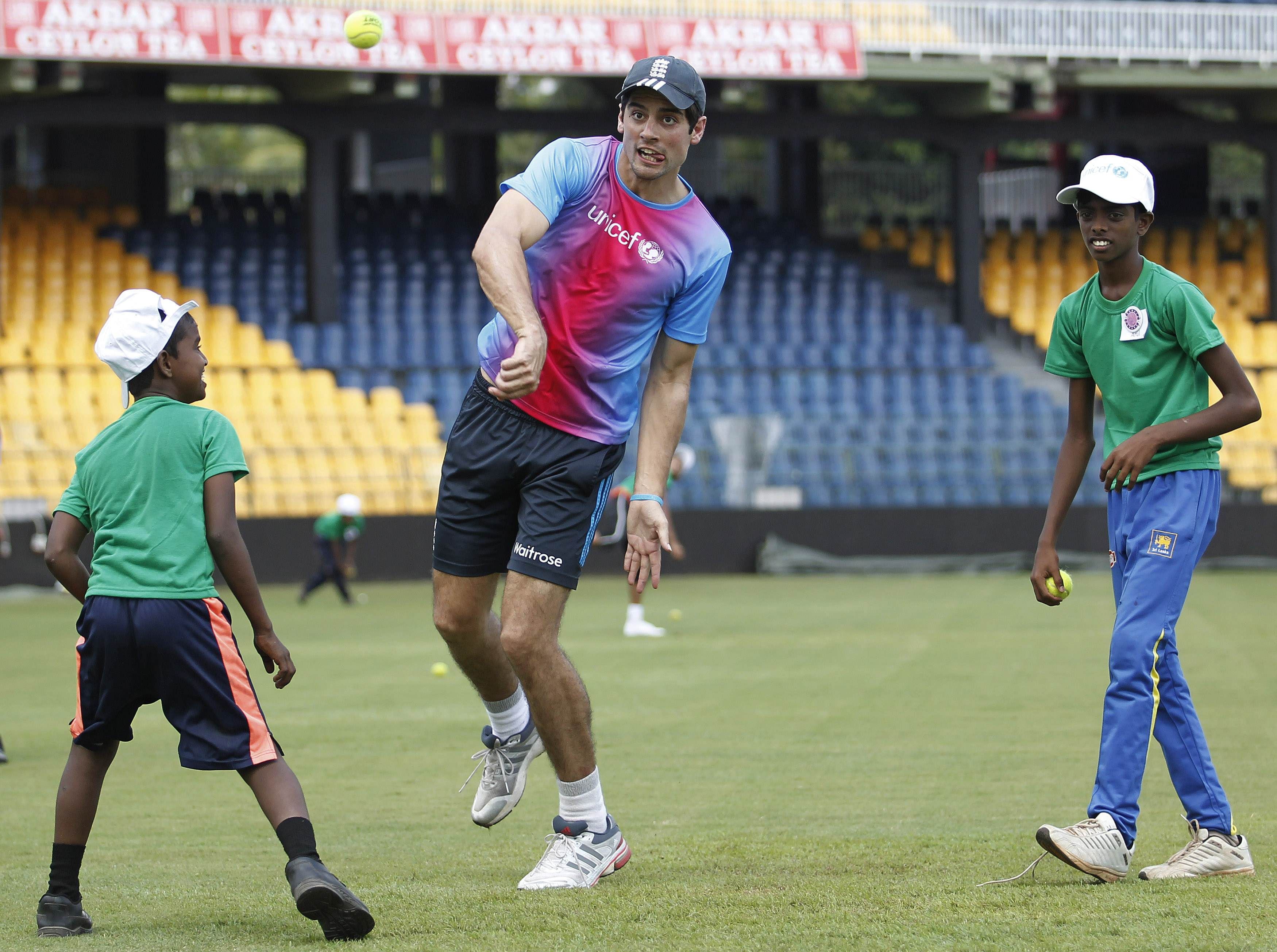 Englandu00e2u20acu2122s captain Alastair Cook (centre) uses a softball to bowl at a coaching camp for some 40 children before a practice session ahead of their fourth cricket match against Sri Lanka in Colombo December 6, 2014. u00e2u20acu201d Reuters pic