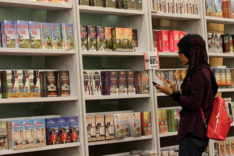 A woman looks over the selection of books for sale at the Malaysia Book Expo 2014 in Kuala Lumpur, December 10, 2014. u00e2u20acu201d Picture by Yusof Mat Isa