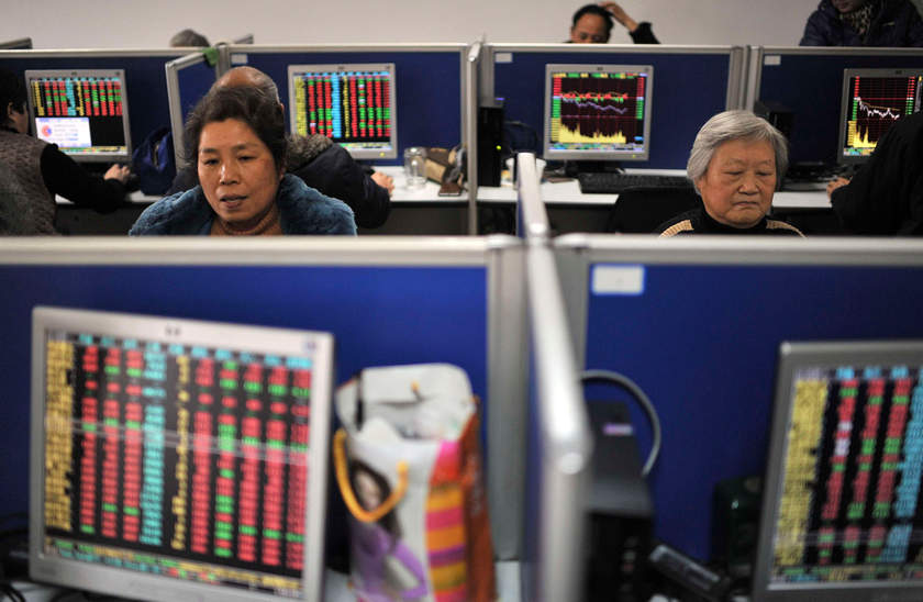 Investors look at computer screens at a brokerage house in Hefei, Anhui province December 24, 2014. u00e2u20acu201d Reuters pic