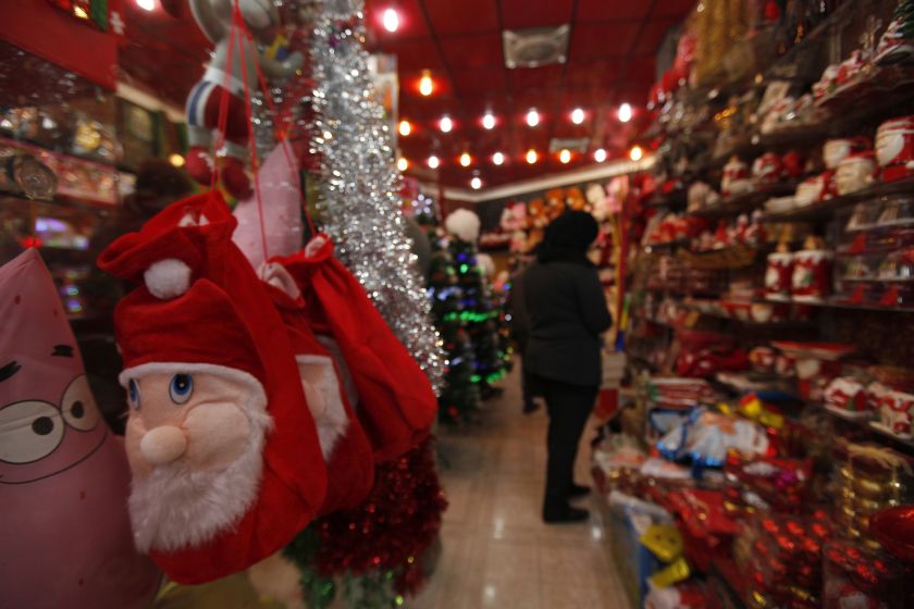 A woman shops for Christmas decorations at a market in Baghdad, December 24, 2014. u00e2u20acu2022 Reuters pic