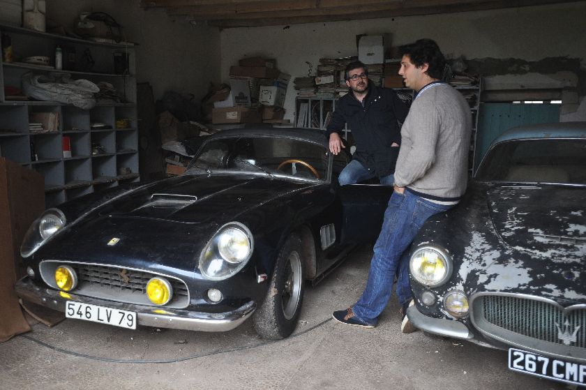 Artcurial managing director Matthieu Lamoure (L) and expert Pierre Novikov November 26, 2014, with Ferrari F250 Spider that once belonged to French actor Alain Delon at the Gaillard property in Echire. AFP 