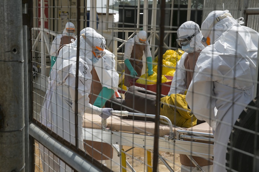 British health workers lift a newly admitted Ebola patient onto a wheeled stretcher in to the Kerry town Ebola treatment centre outside Freetown December 22, 2014. u00e2u20acu201d Reuters pic
