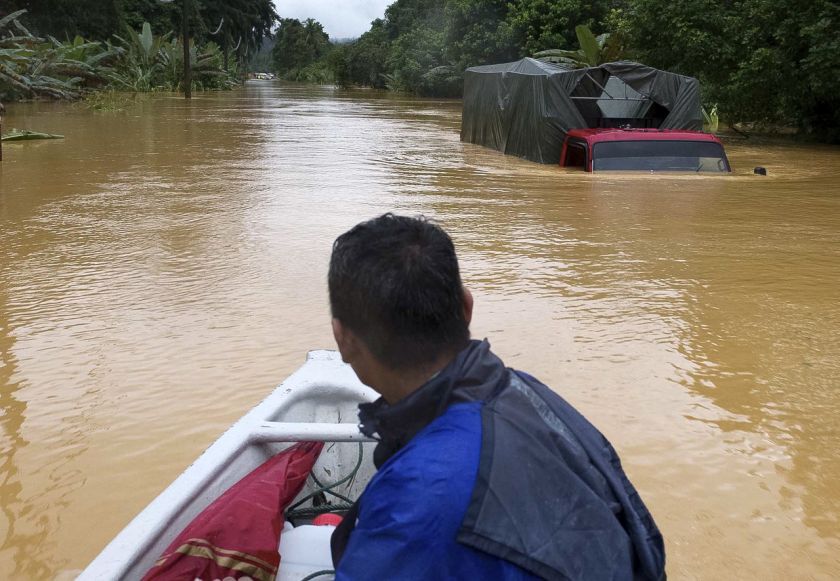 A lorry is inundated with water at Jalan Jeli-Gua Musang due to the overflowing riverbanks, December 25, 2014. u00e2u20acu2022 Bernama pic
