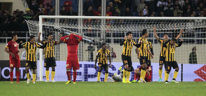 Malaysiau00e2u20acu2122s players (in yellow) celebrate their victory against Vietnam after the second leg of their Asean Football Federation Suzuki Cup 2014 semi-final match at My Dinh stadium in Hanoi December 11, 2014. REUTERS/Kham 