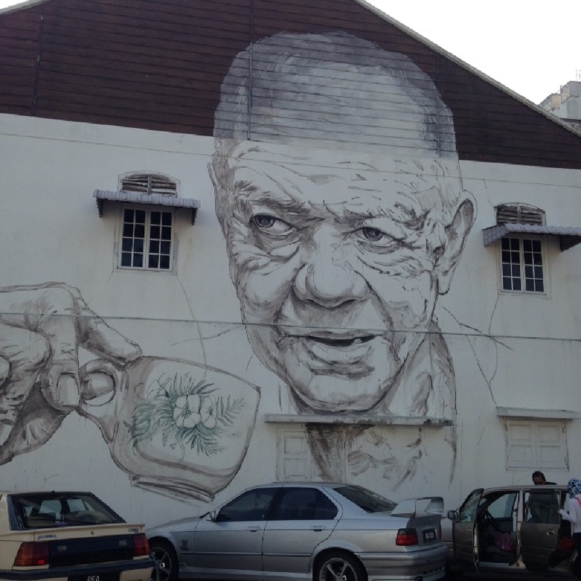 Famed street artist Ernest Zacharevic may have to modify his painting of an old man sipping from a traditional coffee cup, after it was alleged the mural resembles former Malayan Communist Party leader Chin Peng. u00e2u20acu201d Picture by Joan Lau 