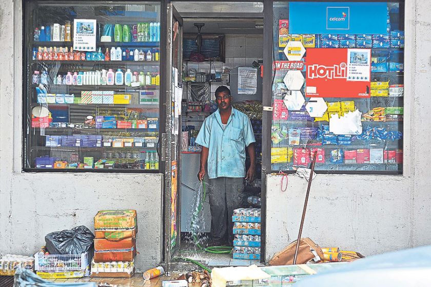 Sundry shop owner Jaheer cleans his store following the flash floods that hit Kuala Lumpur on Thursday. u00e2u20acu201d Picture by Hafiz Sohaimi 