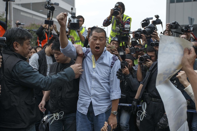 Tycoon and Apple Daily Newspaper owner Jimmy Lai shouts slogan before he is taken away by police officer at an area previously blocked by pro-democracy supporters, outside the government headquarters in Hong Kong, December 11, 2014. u00e2u20acu201du00c2u00a0Reuters pic
