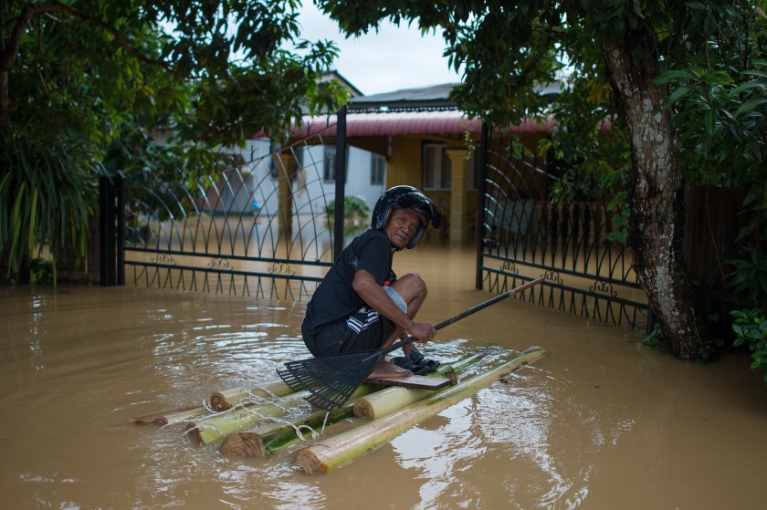A man makes his way to his house submerged in floodwaters in Pengkalan Chepa, near Kota Baru, Kelantan on December 28, 2014. u00e2u20acu201d AFP pic
