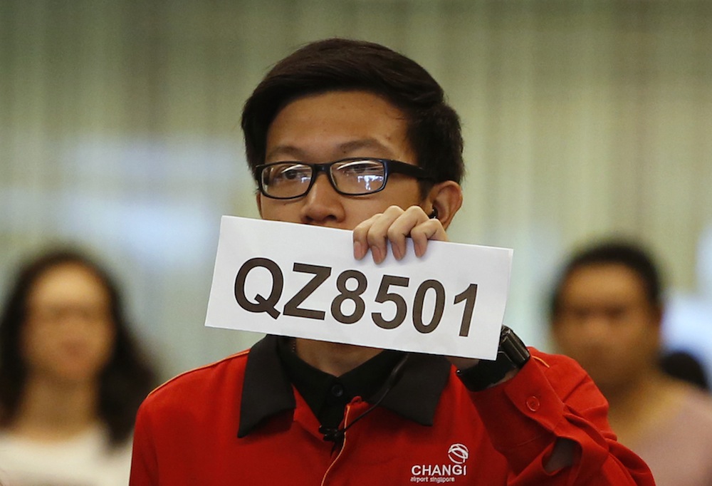 A Changi Airport staff holds up a sign to direct possible next-of-kin of passengers of AirAsia flight QZ 8501 from Indonesian city of Surabaya to Singapore, at Changi Airport in Singapore December 28, 2014. u00e2u20acu201d Reuters pic