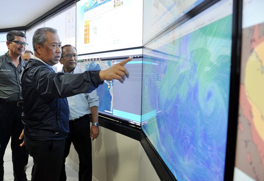 Deputy Prime Minister Tan Sri Muhyiddin Yassin looks at the screen showing wind direction during his visit to the National Disaster Command Centre. u00e2u20acu201d Bernama pic