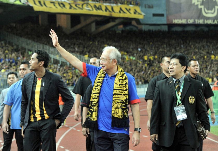 Prime Minister Datuk Seri Najib Tun Razak waves to supporters as he arrives at the National Stadium to give support to national football team Harimau Malaya in the second match of the AFF Suzuki Cup finals against Thailand, December 20, 2014. u00e2u20acu201d Bernama 