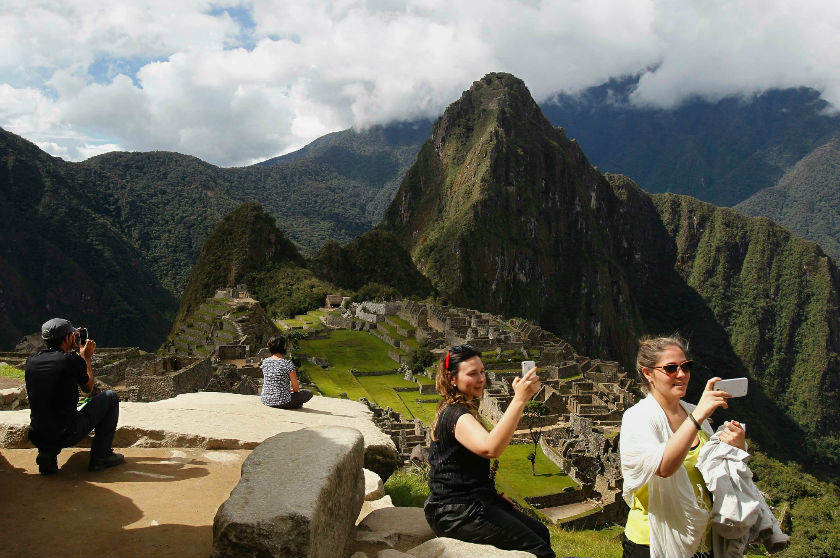 Visitors take photos with their mobile phones at the Inca citadel of Machu Picchu in Cusco December 3, 2014. Machu Picchu, a Unesco World Heritage Site, is Peru’s top tourist attraction.