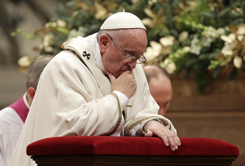 Pope Francis kneels as he leads the Christmas night mass in Saint Peter's Basilica at the Vatican December 24, 2014.u00c2u00a0u00e2u20acu201du00c2u00a0Reuters pic