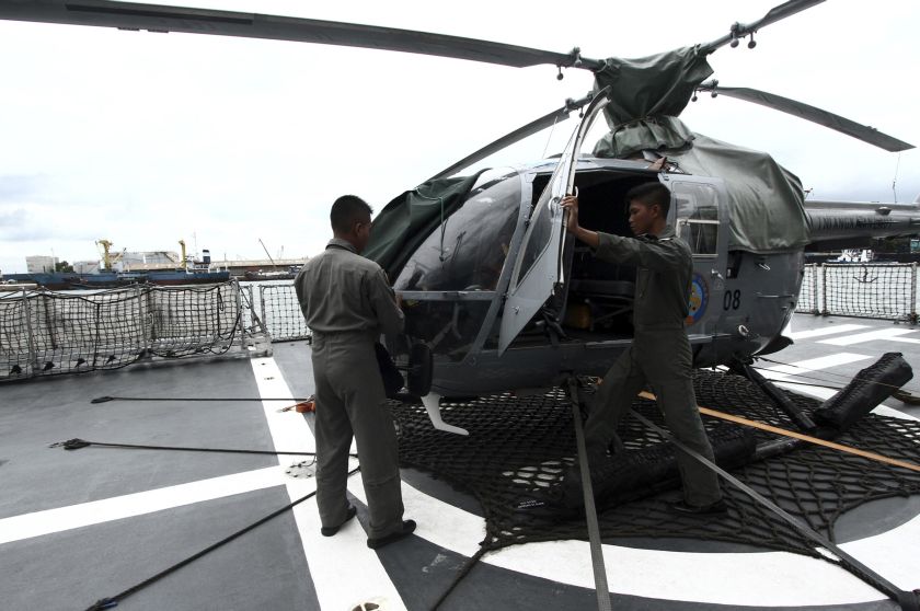 Indonesian Navy soldiers check a helicopter on the deck of KRI Sultan Hasanuddin-366 warship before joining in search operations for AirAsia flight QZ8501 at Batuampar port in Batam, December 30, 2014. u00e2u20acu201d Reuters pic