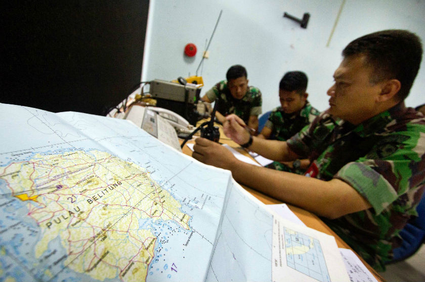 Army soldiers sit near a map of Belitung island while monitoring search operations for AirAsia flight QZ8501 at Halim Perdanakusuma airport in Jakarta, December 29, 2014. u00e2u20acu201d Reuters pic